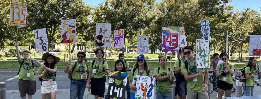 Orientation Leaders pose with their numbered signs.