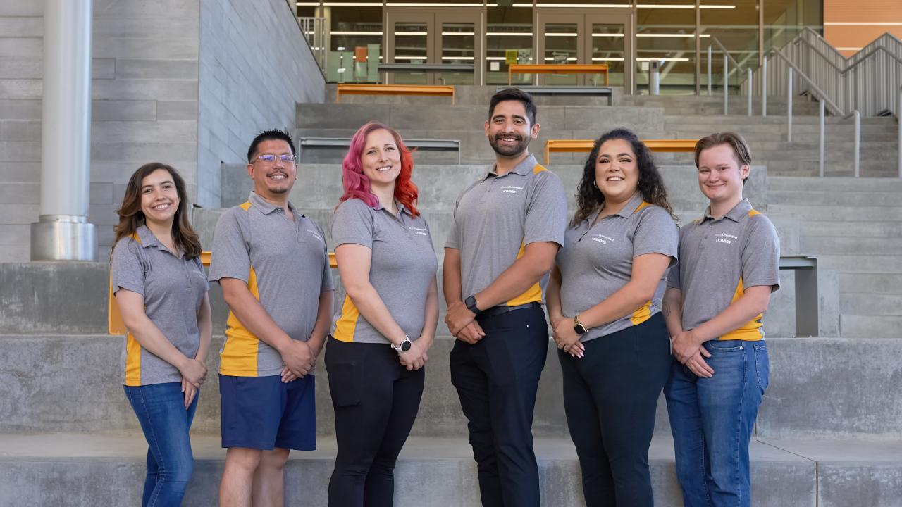 Orientation professional staff pose for a photo.