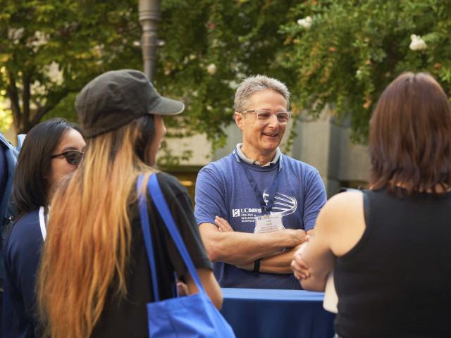 Two students meet a professor.