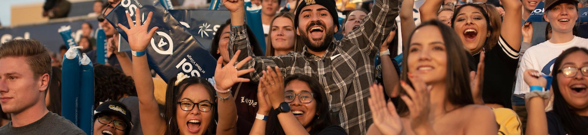 Students cheering at the football stadium