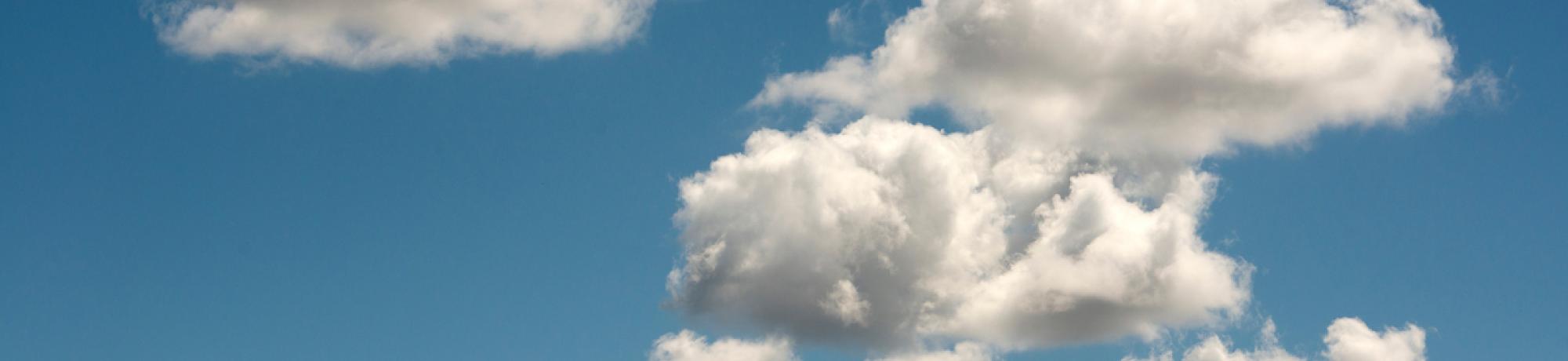 A few white clouds drift across a blue sky.