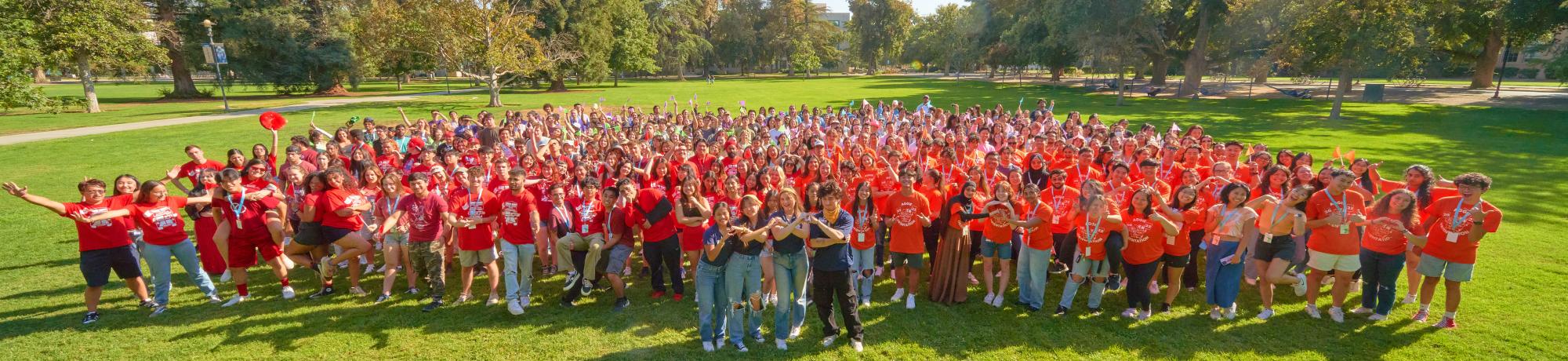 400 OLs stand in a group on a grassy field.